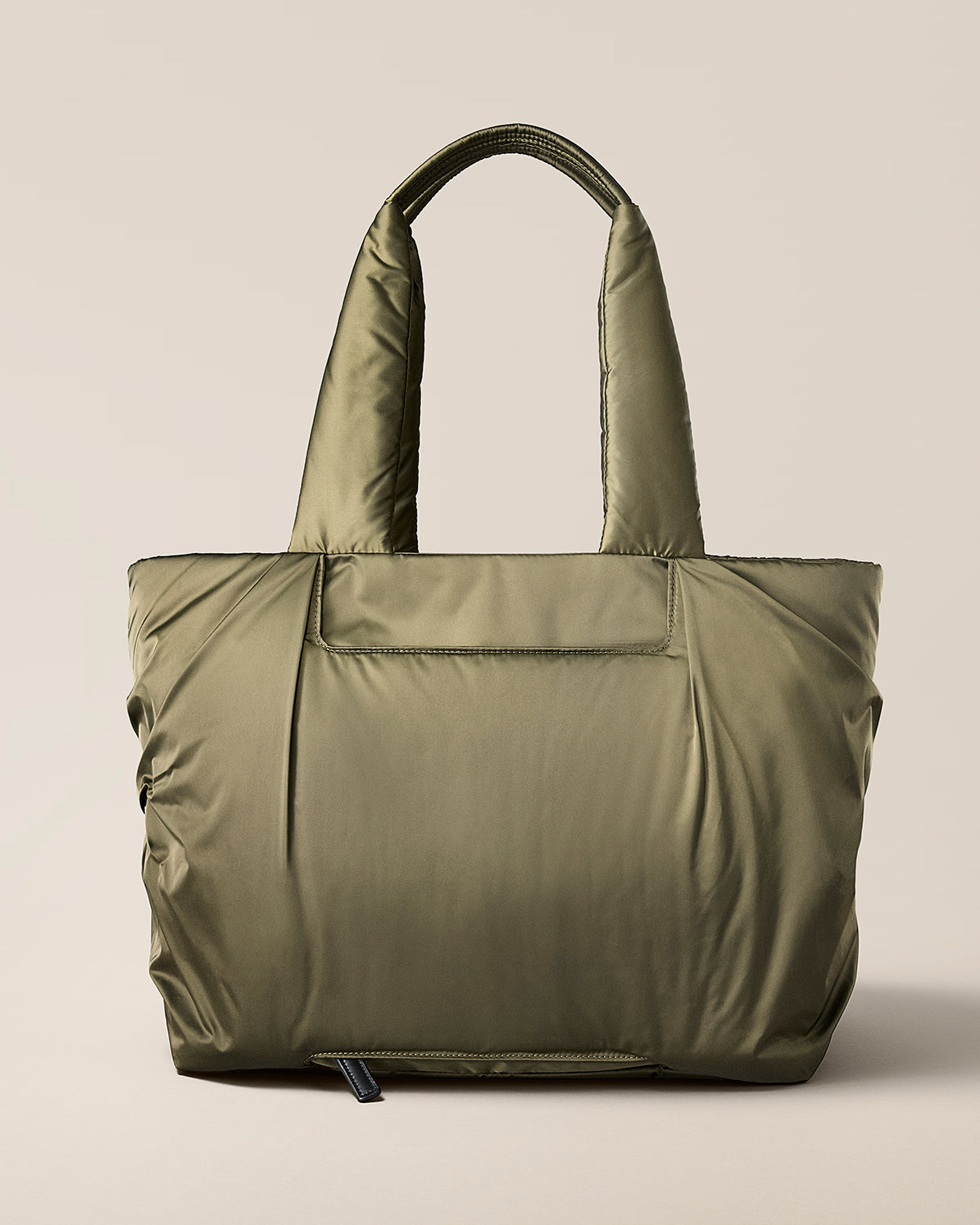 TYVY Aviator Tote bag optimized for travel on a beige background