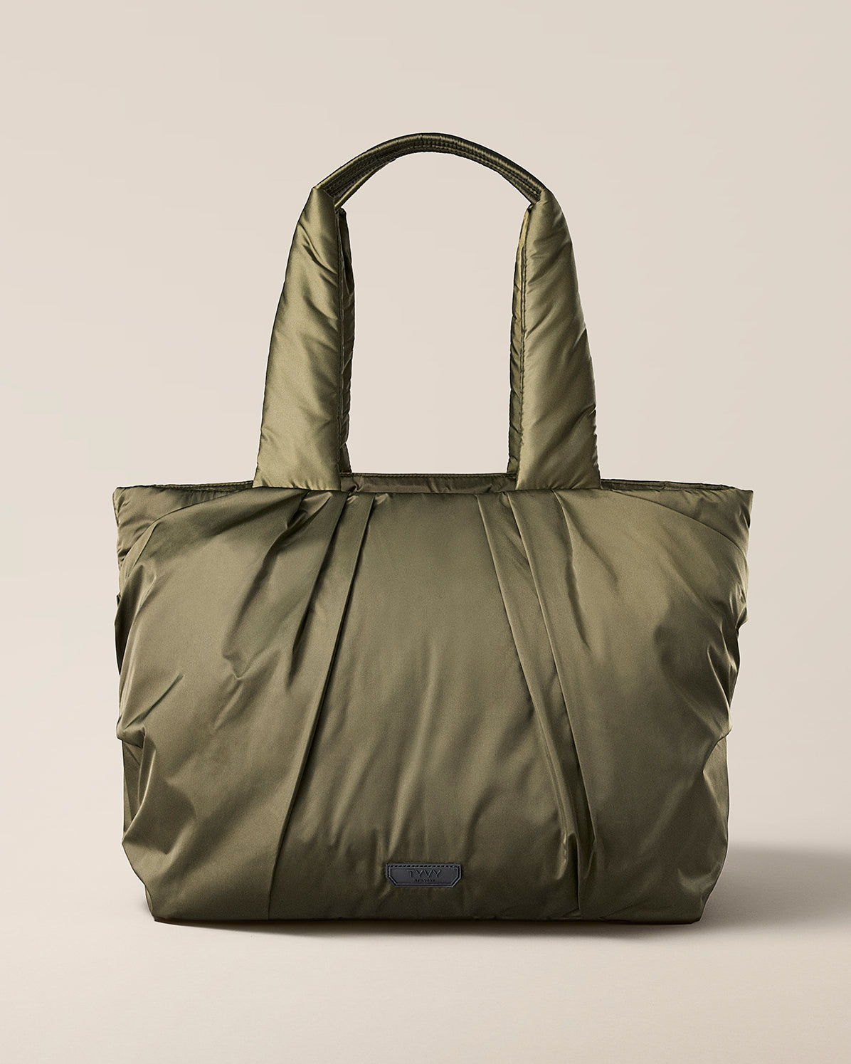 TYVY Aviator Tote bag optimized for travel. Olive Green tote bag on a beige background